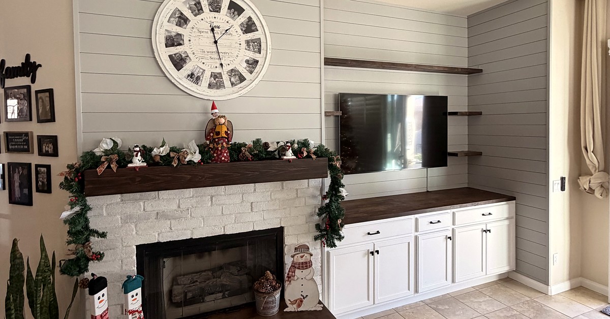 Custom fireplace entertainment wall with painted brick, shiplap, shelves and built-in white cabinets